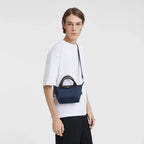 Navy Longchamp Le Pliage Energy XS handbag with structured shape and short handles, showcasing a compact, stylish design.