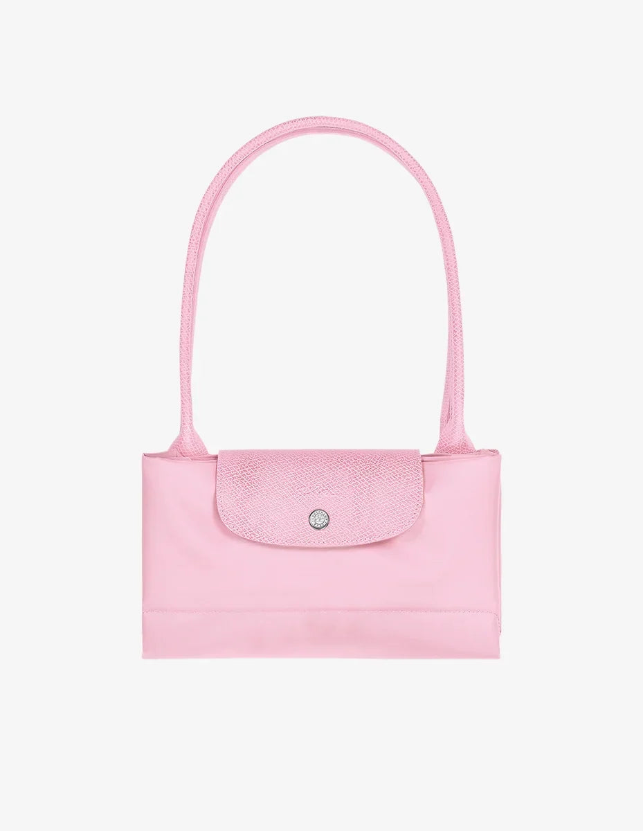 Longchamp Le Pliage Green L Tote bag in pink fabric, showcasing its spacious design and sturdy handles.