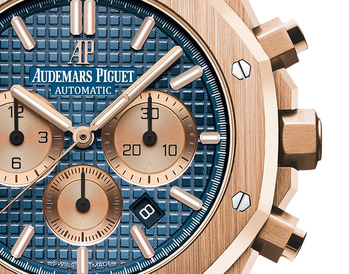 Audemars Piguet Royal Oak men's watch with gold case, silver dial, and stainless steel bracelet, showcasing an elegant luxury timepiece.