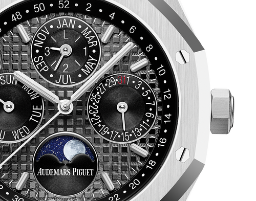 Audemars Piguet Royal Oak men's watch with a gold case and blue dial, showcasing a luxury timepiece with a textured bracelet.