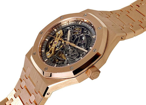 Audemars Piguet Royal Oak men's watch with gold case, silver dial, and stainless steel bracelet, showcasing luxury timepiece details.