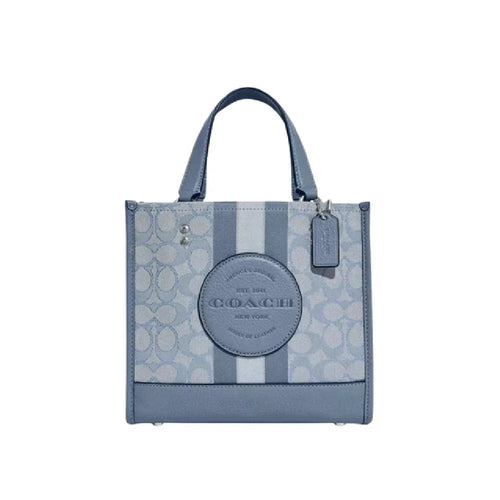 Light blue Coach Dempsey Tote bag in signature canvas with top handles and spacious interior, stylish and versatile for daily use.
