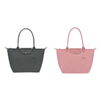 The Le Pliage Duo: Le Pliage Green M Tote in Graphite and Petal Pink side by side